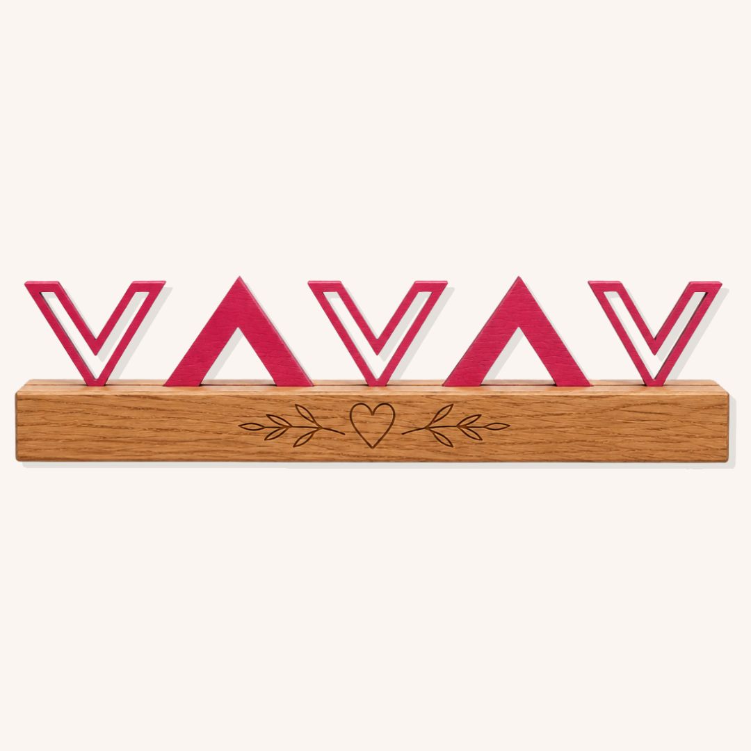 Blush pink geometric wooden show jump filler with repeating chevron shapes and custom pine base on a plain background