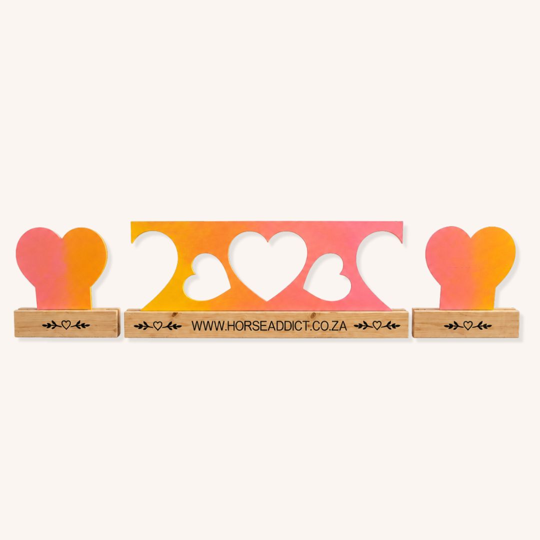 Pink orange and yellow wooden heart show jump filler set with central heart cut-out panel and custom pine bases